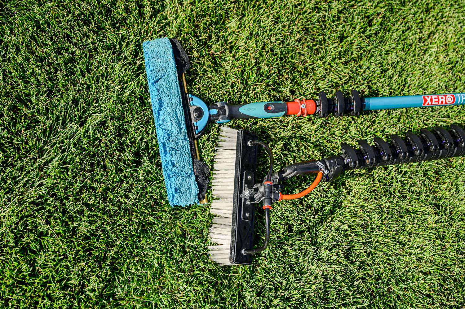 Trad Pole with Ultimate Squeegee Combo Laying on grass with a XERO Water Fed Pole
