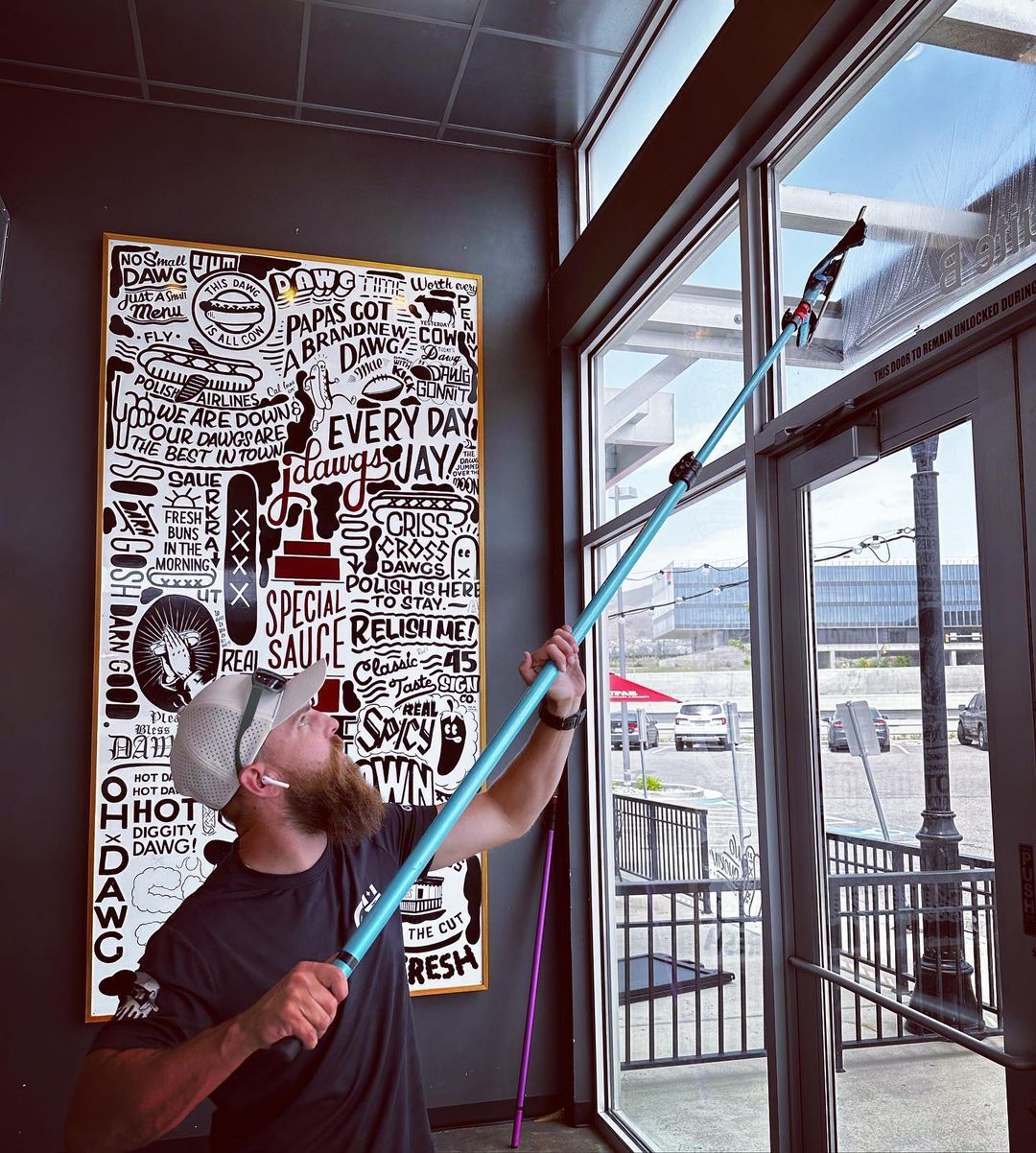 Cleaning Storefront windows with Trad Pole and Squeegee