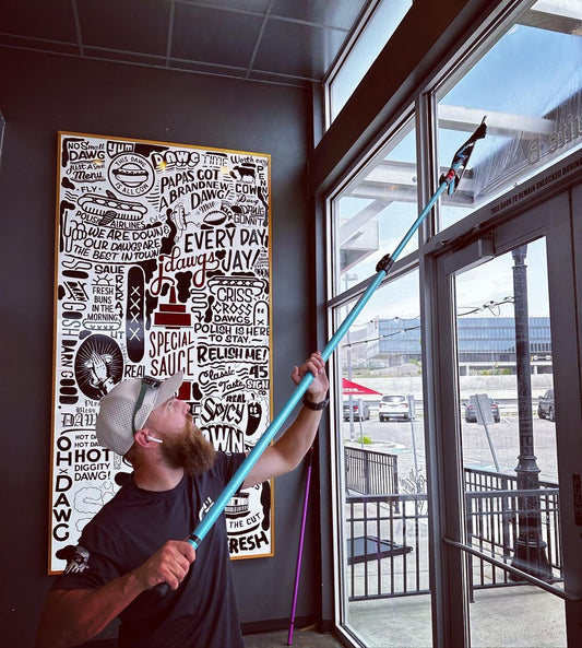 Cleaning Storefront windows with Trad Pole and Squeegee