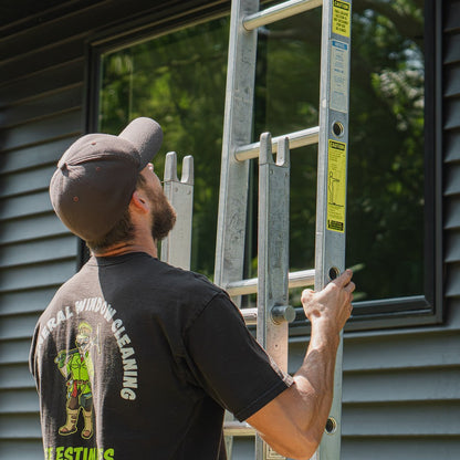 Metallic Ladder Aluminum Center Section in 6 Foot Being Stacked so a Window Cleaner can Clean Windows.