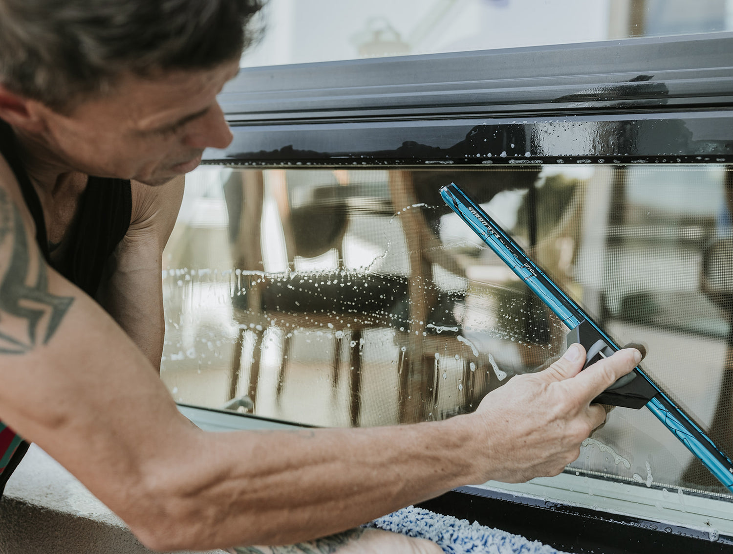 Window Cleaner using a Complete Squeegee on glass